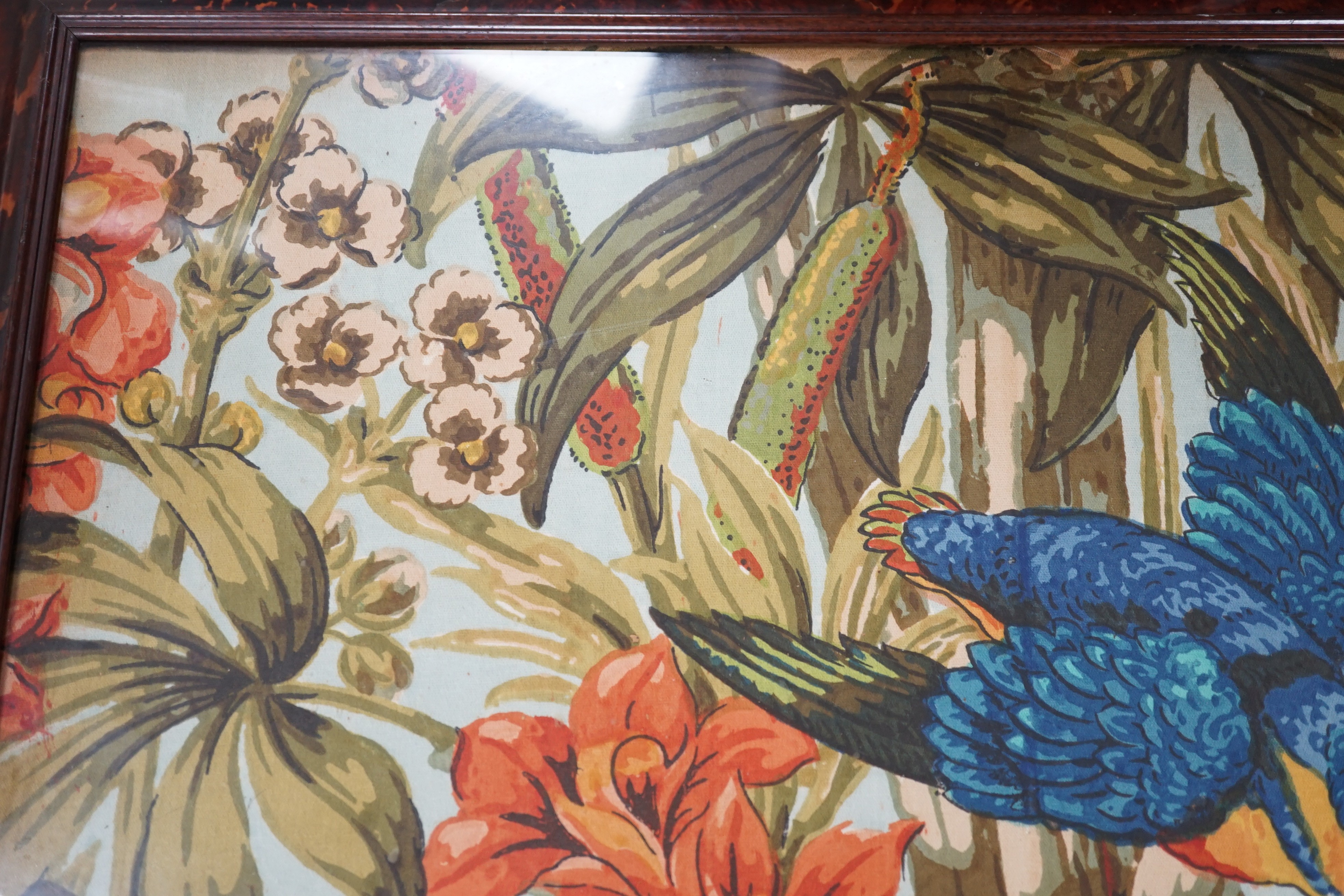 A large rare tortoiseshell picture frame and exotic panel of printed fabric, 70 cms wide x 52 cms high including frame
